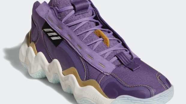View of purple and white adidas shoe.